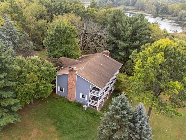 birds eye view of property featuring a water view and a forest view