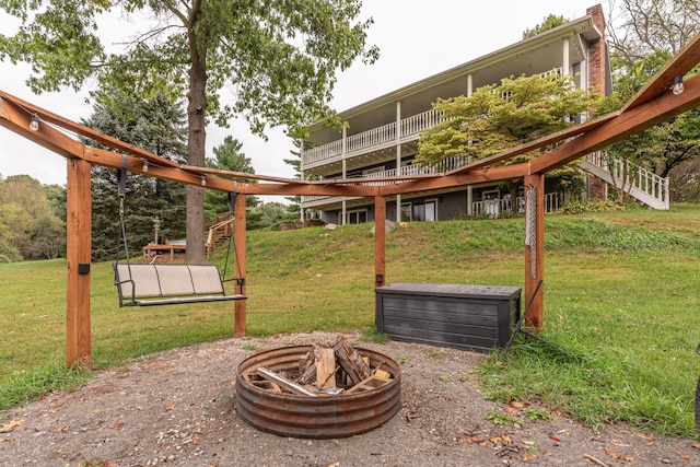 exterior space with a fire pit, stairway, and a wooden deck