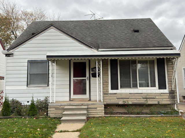 bungalow-style house featuring a front yard