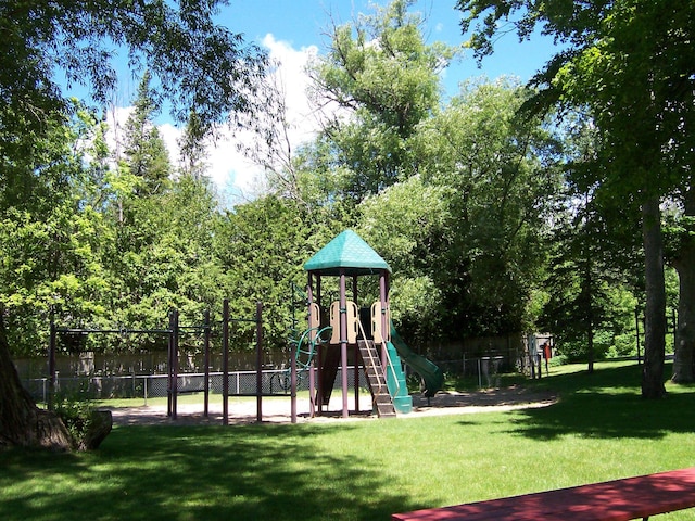 view of jungle gym featuring a lawn