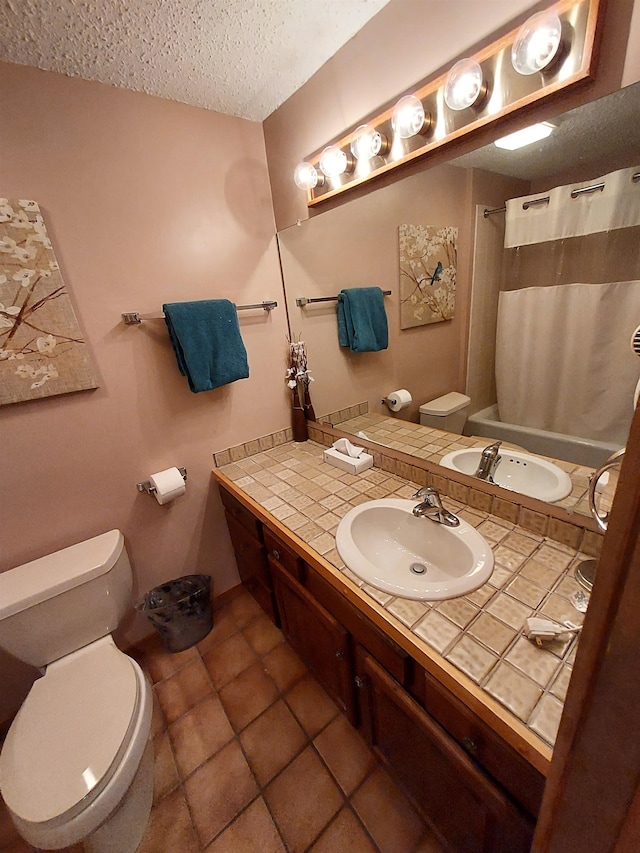 bathroom featuring tile patterned floors, a shower with curtain, vanity, a textured ceiling, and toilet