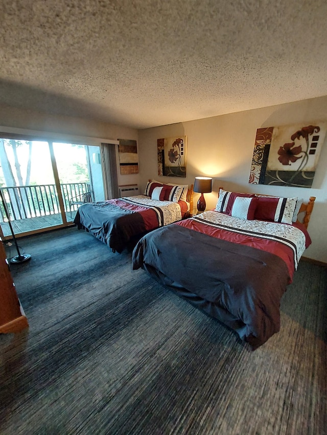 bedroom featuring access to exterior and a textured ceiling