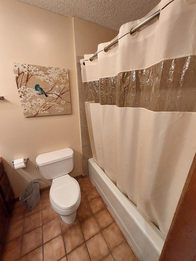 bathroom featuring tile patterned flooring, shower / bath combo, toilet, and a textured ceiling