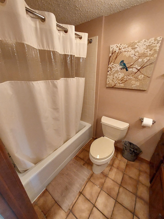 bathroom with tile patterned flooring, shower / bath combo, toilet, and a textured ceiling