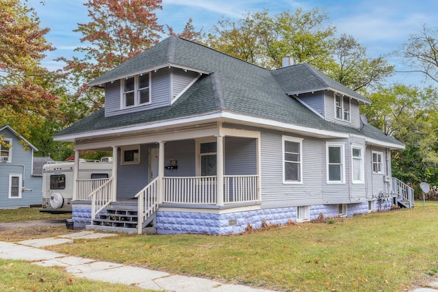 view of front of property with covered porch and a front yard