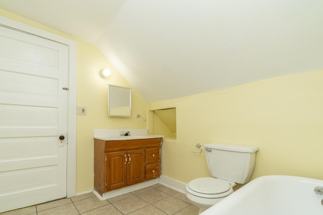 bathroom featuring tile patterned flooring, vanity, lofted ceiling, and toilet