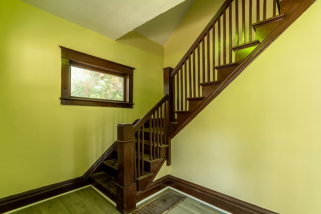 stairs with hardwood / wood-style flooring