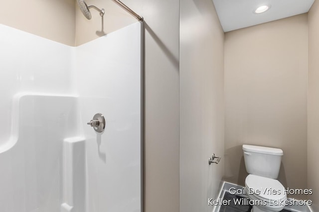 bathroom with a shower and toilet