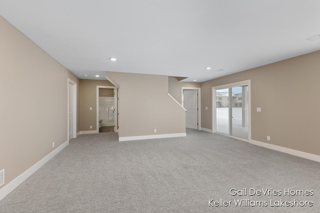 spare room featuring baseboards, light colored carpet, and recessed lighting