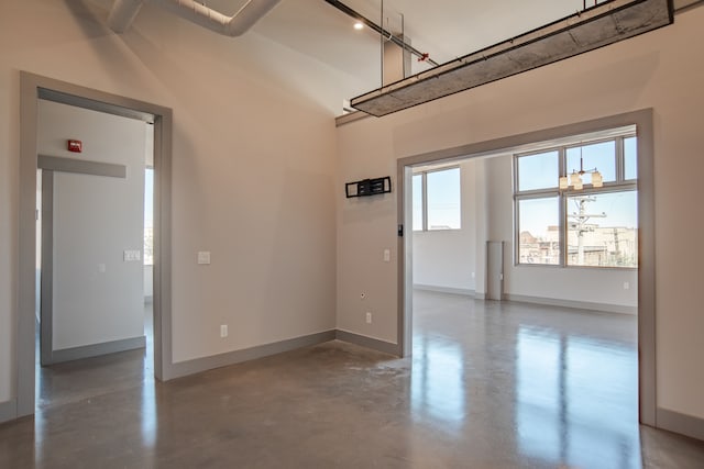 interior space with concrete flooring and a notable chandelier