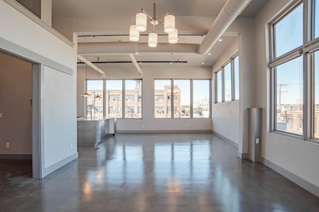 unfurnished room featuring a notable chandelier and sink