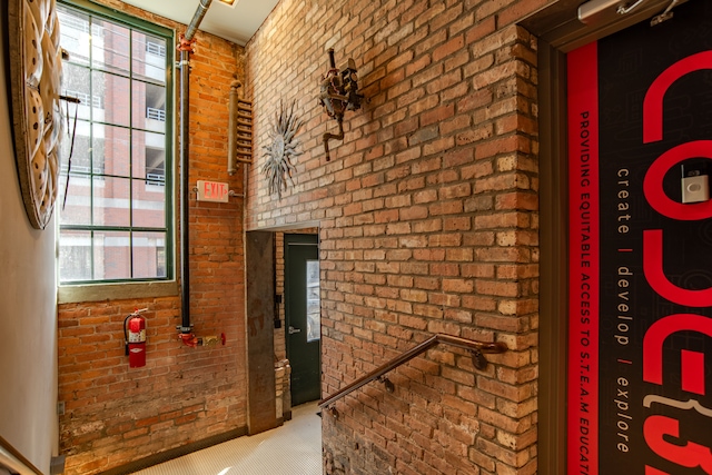 corridor featuring brick wall