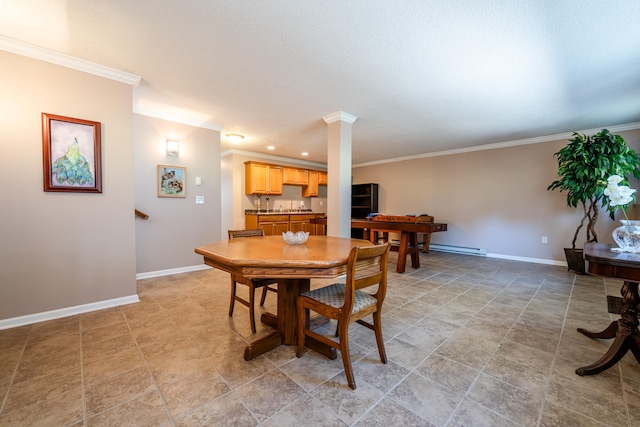 dining space featuring decorative columns, baseboard heating, and ornamental molding