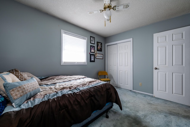 bedroom with carpet flooring, ceiling fan, and a textured ceiling