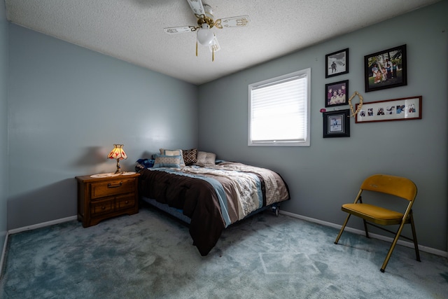 bedroom with ceiling fan, carpet, and a textured ceiling