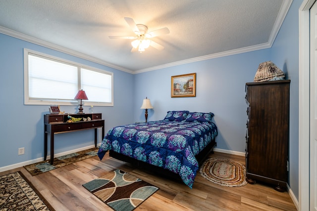 bedroom featuring hardwood / wood-style floors, a textured ceiling, ceiling fan, and ornamental molding