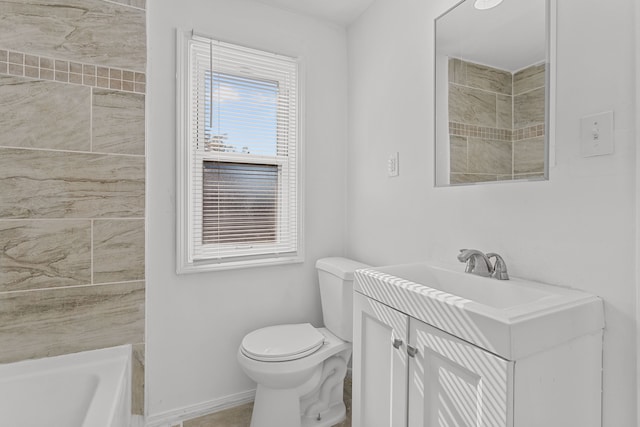 bathroom featuring a washtub, vanity, and toilet