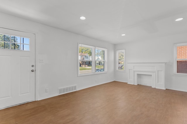 unfurnished living room featuring wood-type flooring