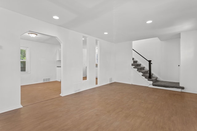 unfurnished living room with wood-type flooring