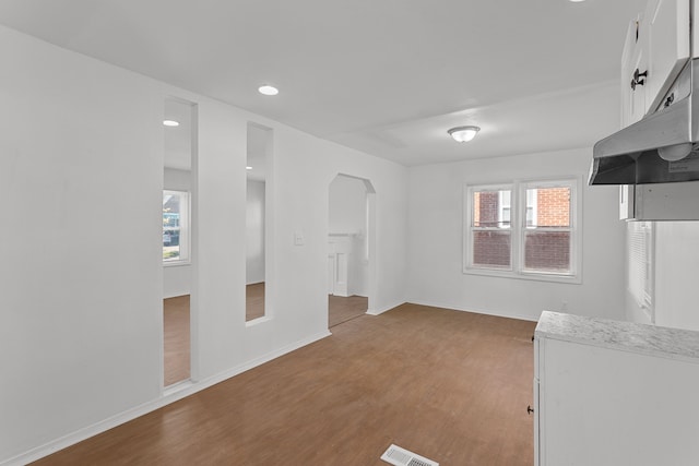 unfurnished living room featuring hardwood / wood-style flooring