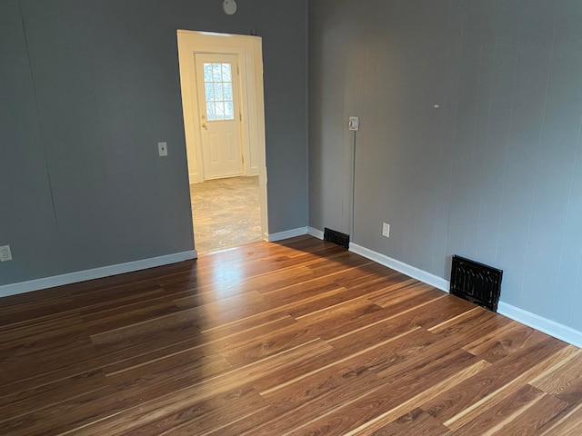 empty room featuring dark hardwood / wood-style flooring