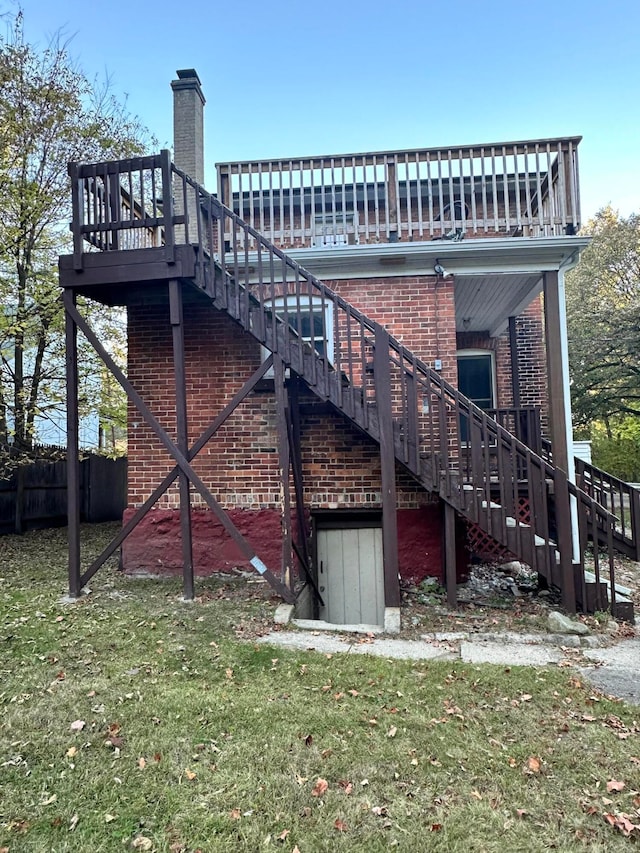 rear view of house featuring a yard