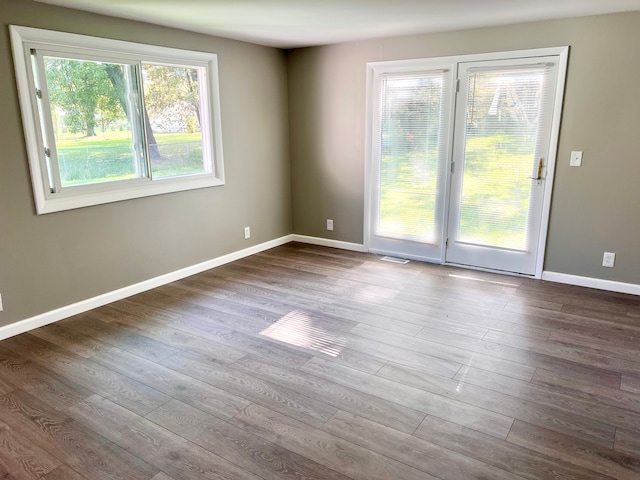 unfurnished room featuring hardwood / wood-style floors