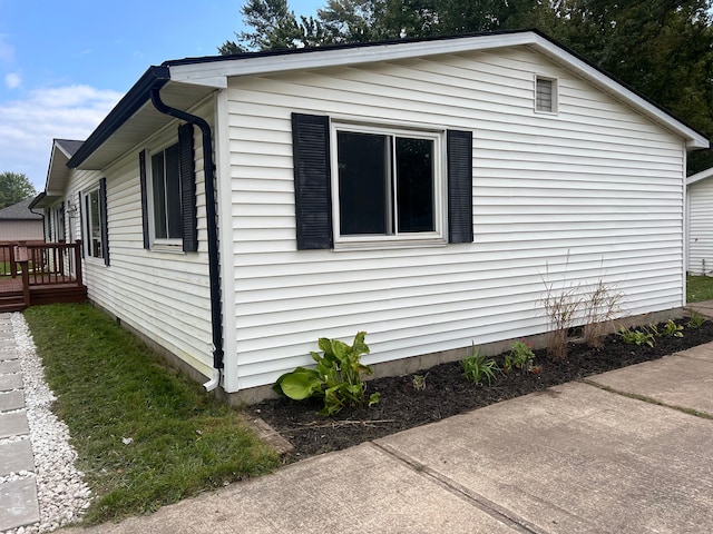 view of side of property featuring a deck