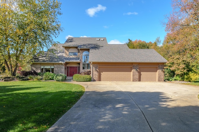 view of front of home featuring a front yard and a garage