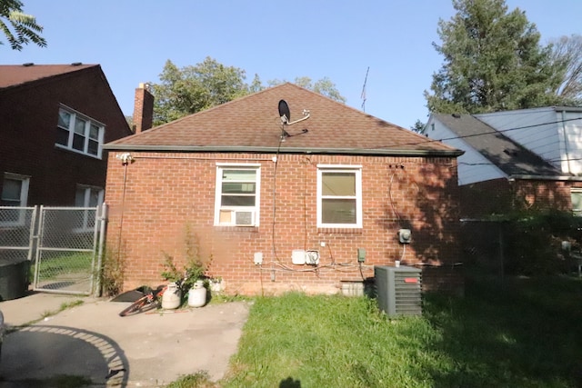 rear view of property with cooling unit