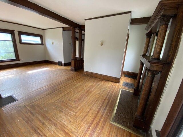 925 W Lovell St, Kalamazoo, MI 49007 - spare room with baseboards, decorative columns, and a fireplace