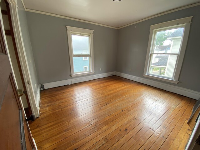 925 W Lovell St, Kalamazoo, MI 49007 - empty room featuring wood-type flooring, ornamental molding, and baseboards