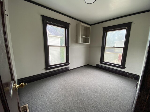 925 W Lovell St, Kalamazoo, MI 49007 - carpeted empty room featuring crown molding and baseboards