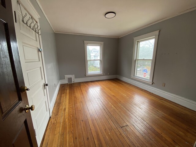 925 W Lovell St, Kalamazoo, MI 49007 - empty room featuring baseboards, light wood finished floors, healthy amount of natural light, and crown molding