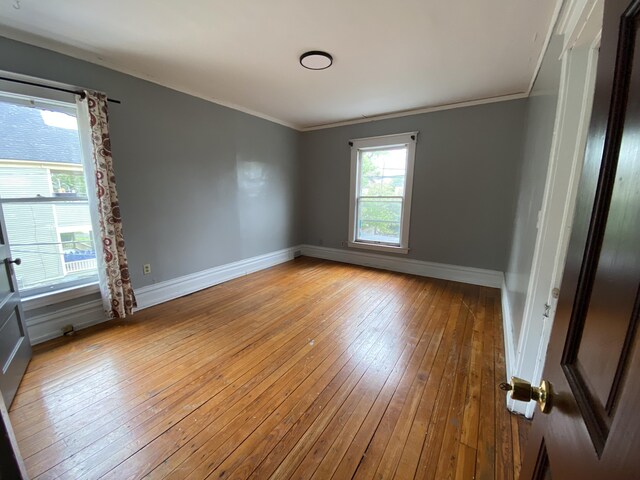 925 W Lovell St, Kalamazoo, MI 49007 - empty room with light wood-style floors, crown molding, and baseboards