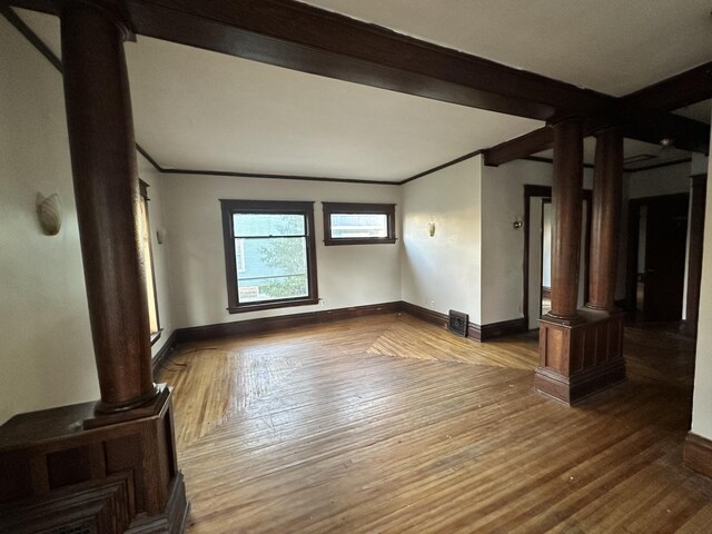 925 W Lovell St, Kalamazoo, MI 49007 - unfurnished room with ornate columns, wood finished floors, ornamental molding, and baseboards