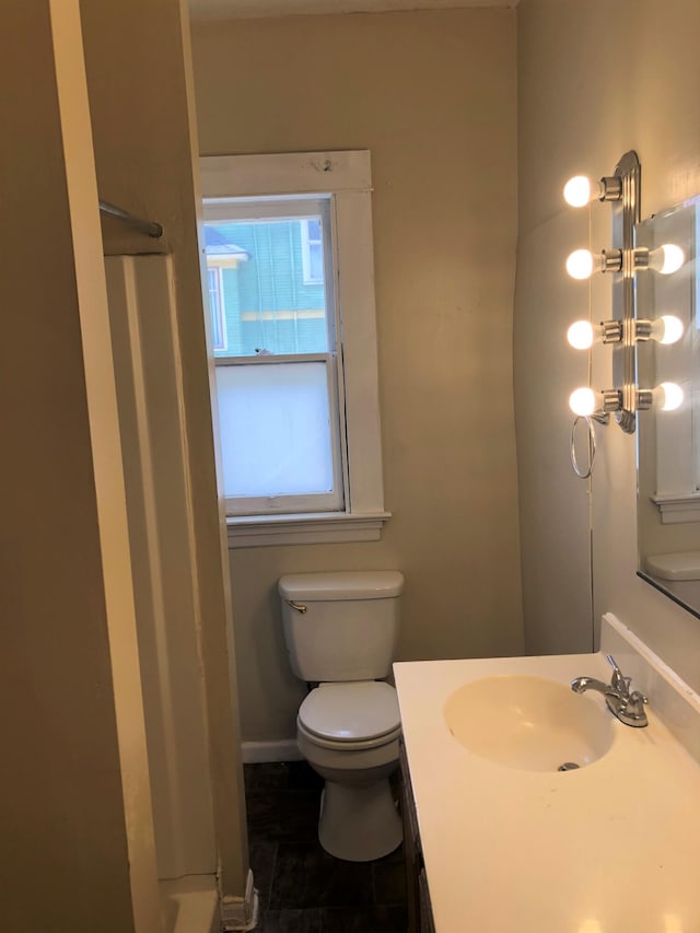 bathroom with tile patterned floors, a shower, vanity, and toilet