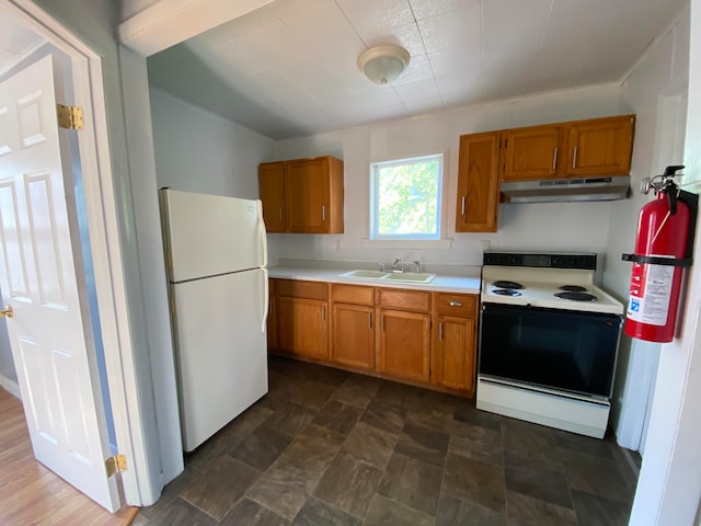 kitchen with sink, exhaust hood, and white appliances