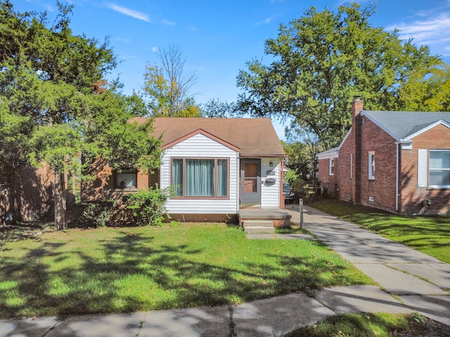 bungalow-style house with a front yard