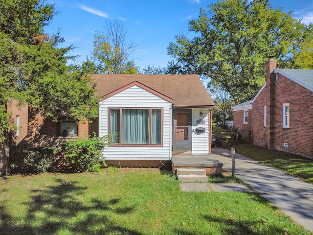 bungalow-style home featuring a front lawn