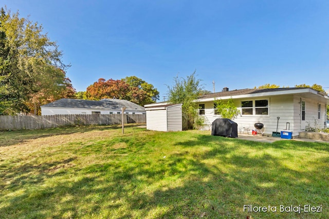 view of yard with a shed and a patio