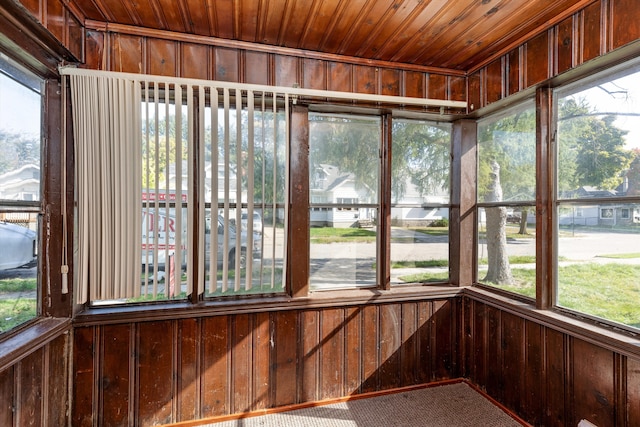 unfurnished sunroom featuring a healthy amount of sunlight and wood ceiling