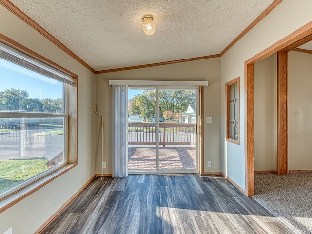 doorway to outside with a textured ceiling, crown molding, a wealth of natural light, and lofted ceiling