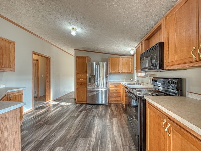 kitchen featuring dark hardwood / wood-style floors, a textured ceiling, lofted ceiling, black appliances, and ornamental molding