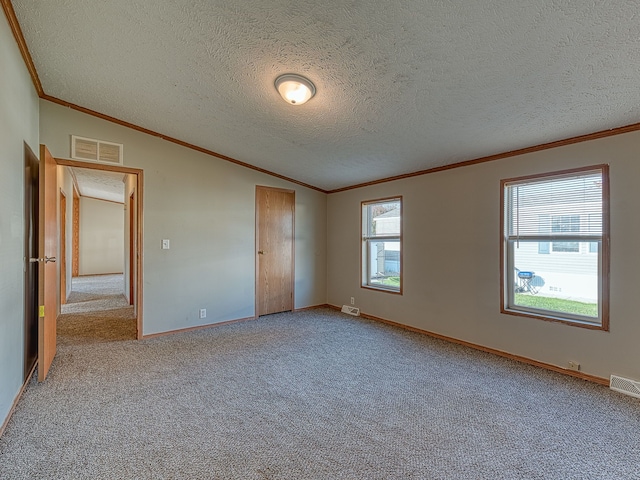 unfurnished bedroom featuring carpet, a textured ceiling, vaulted ceiling, and ornamental molding