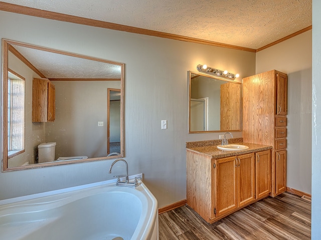 bathroom with vanity, a textured ceiling, crown molding, hardwood / wood-style floors, and toilet