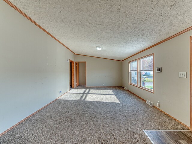 carpeted empty room with a textured ceiling and ornamental molding