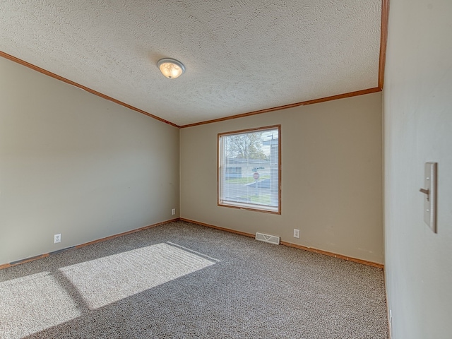 carpeted spare room with ornamental molding and a textured ceiling