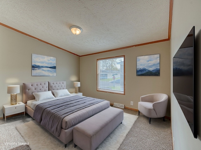 bedroom with light colored carpet, ornamental molding, and a textured ceiling