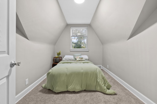 bedroom featuring lofted ceiling and carpet flooring